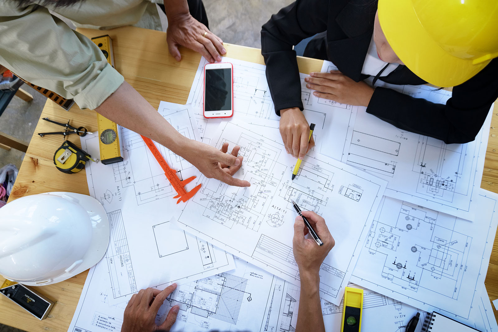 Engineer,People,Meeting,Working,And,Pointing,At,A,Drawings,In